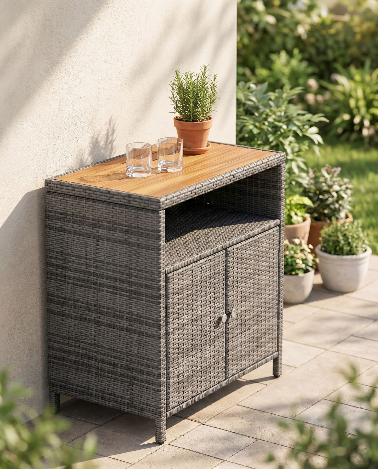 Grey rattan outdoor storage cabinet with acacia wood top on a patio