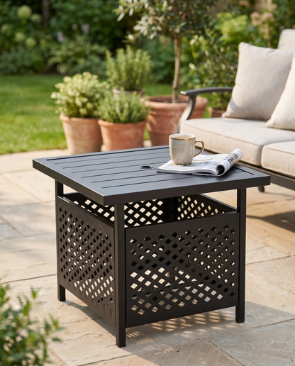 Black metal patio side table with umbrella hole beside an outdoor sofa