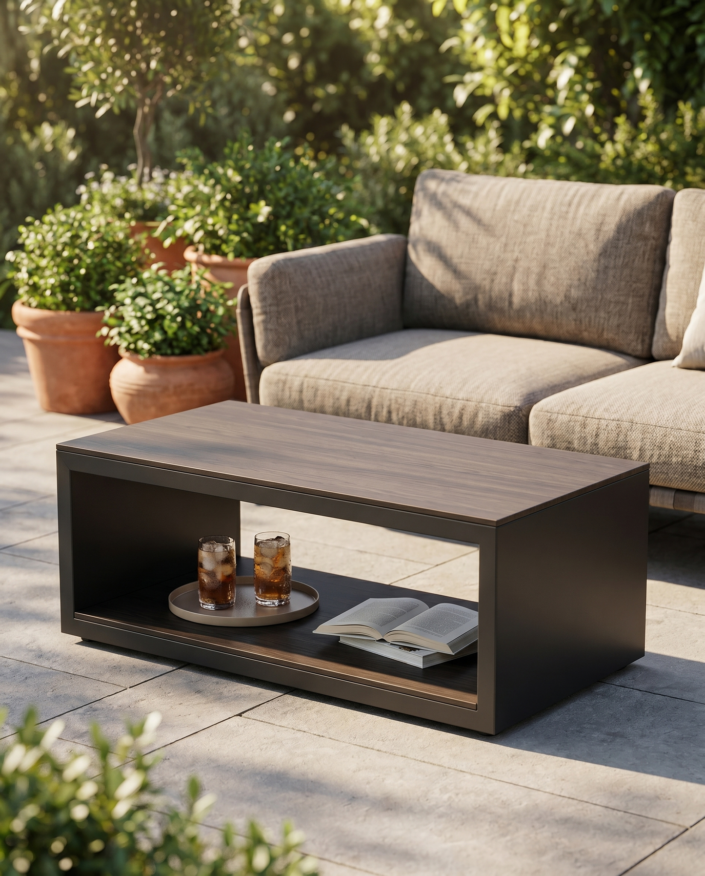 Dark steel outdoor coffee table with wood-grain top in front of a patio sofa