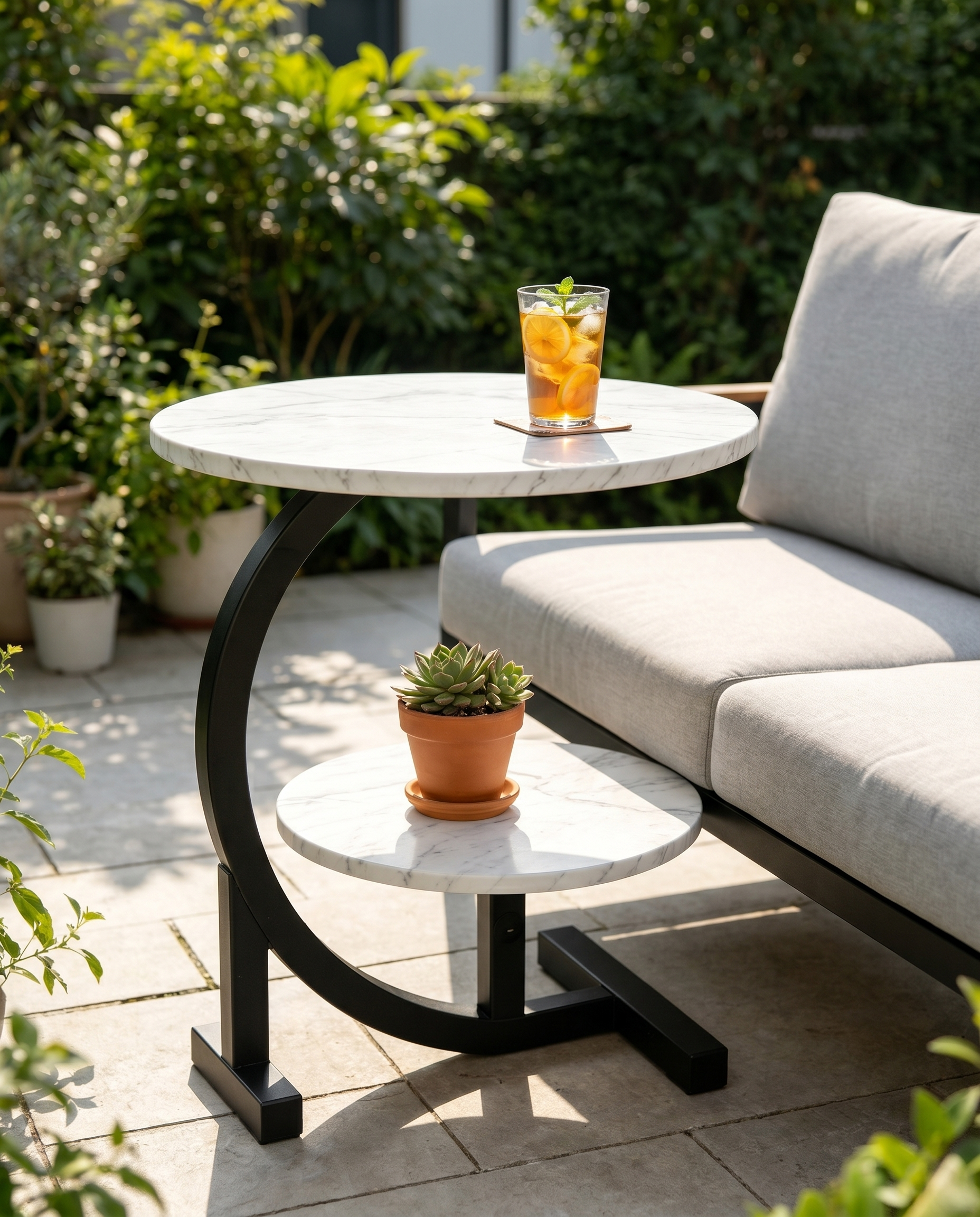Two-tier C-shaped faux-marble side table sliding beside an outdoor sofa
