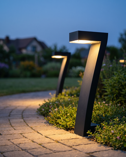 Black solar pathway bollard lights lining a garden path at dusk
