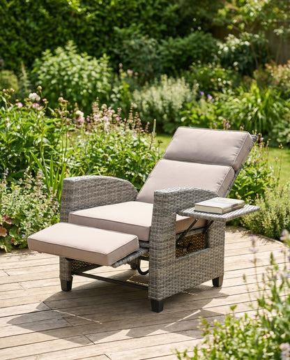 All-weather grey wicker patio recliner with footrest on a garden deck