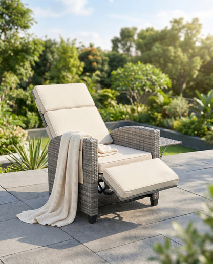Grey wicker outdoor recliner reclined on a bright terrace
