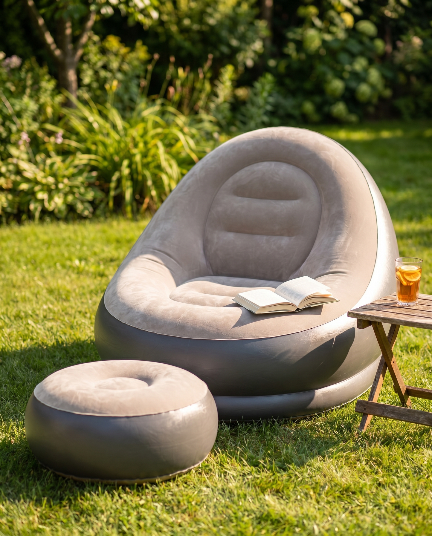 Taupe inflatable lounge chair and footstool on a sunny garden lawn