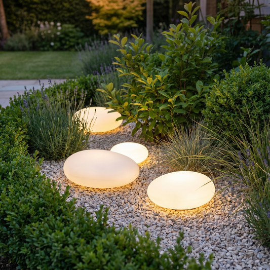 Solar pebble garden lights glowing at dusk, square