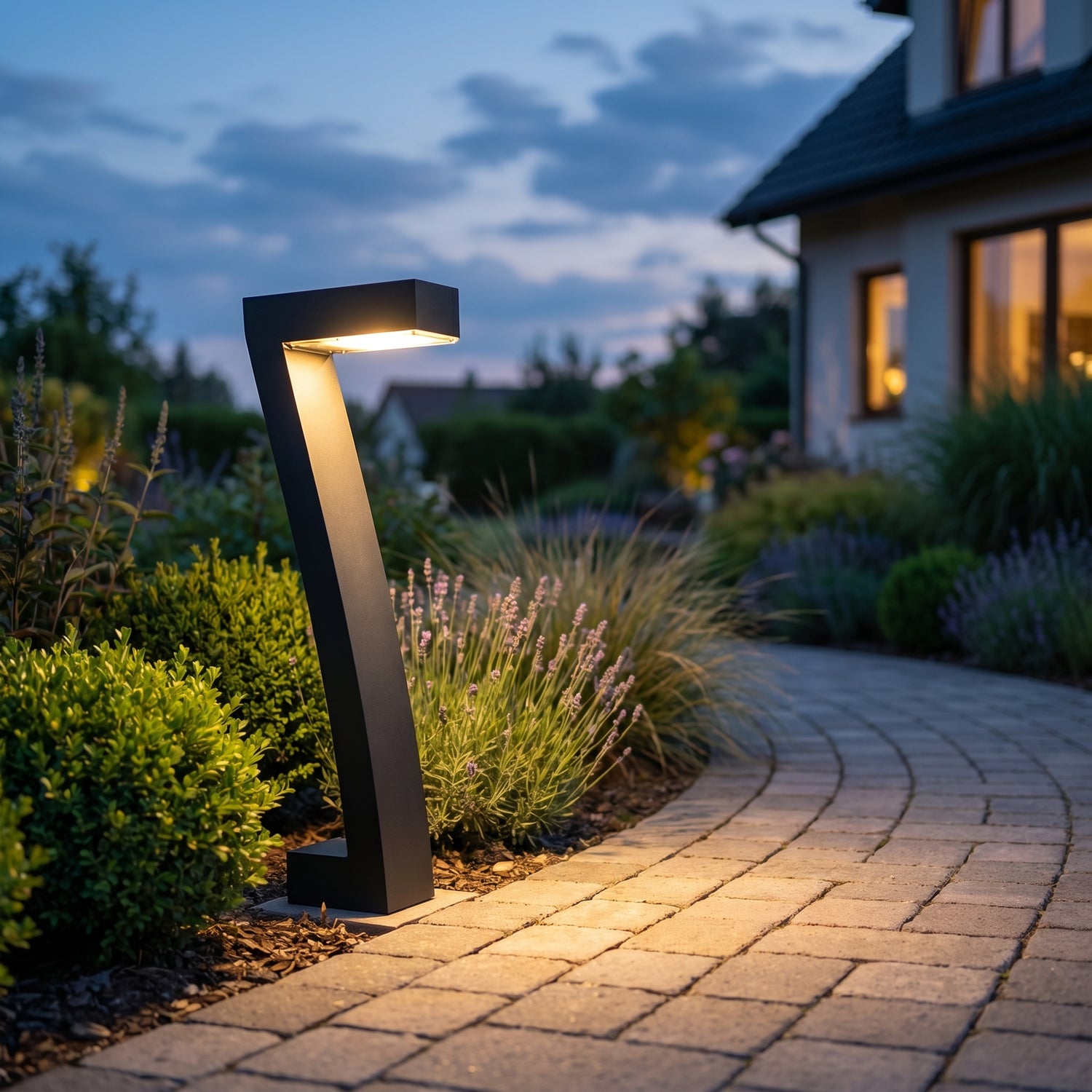 Black solar pathway bollard lights along a garden path at dusk, square