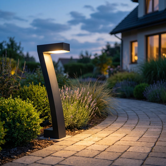 Black solar pathway bollard lights along a garden path at dusk, square