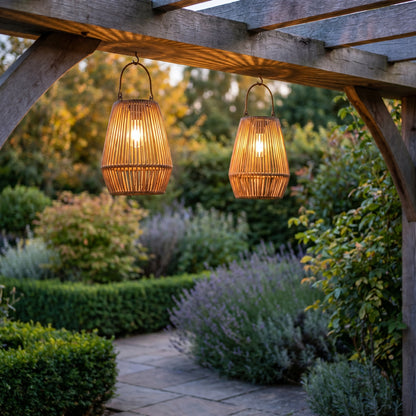 Rattan solar hanging lanterns glowing from a pergola at dusk, square
