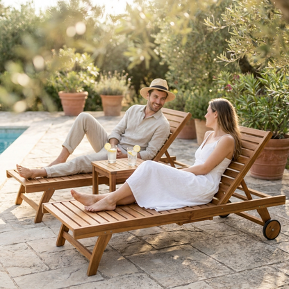 Couple relaxing on a three-piece acacia sun lounger set with tea table